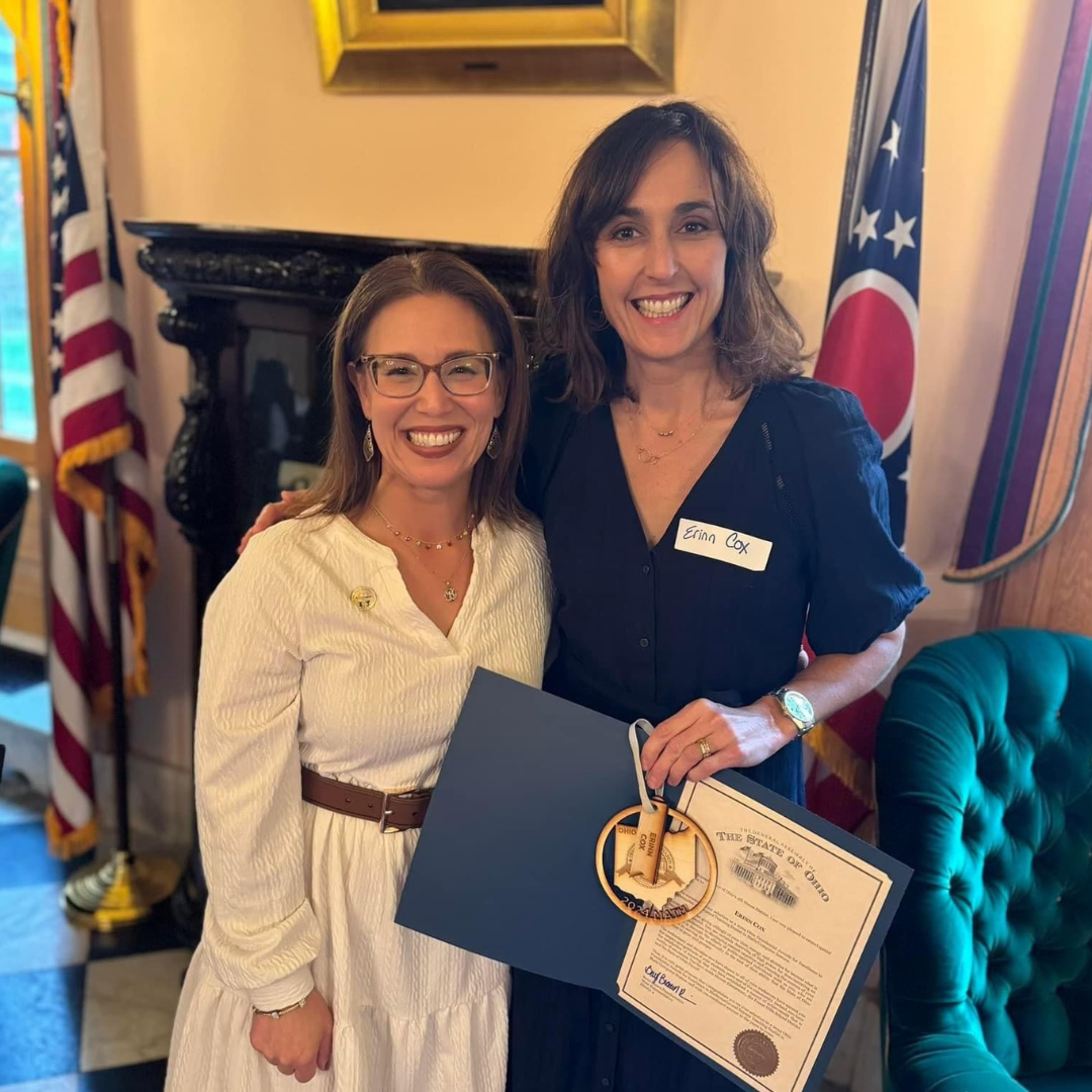 Erinn Cox poses for a photo with her award recognition